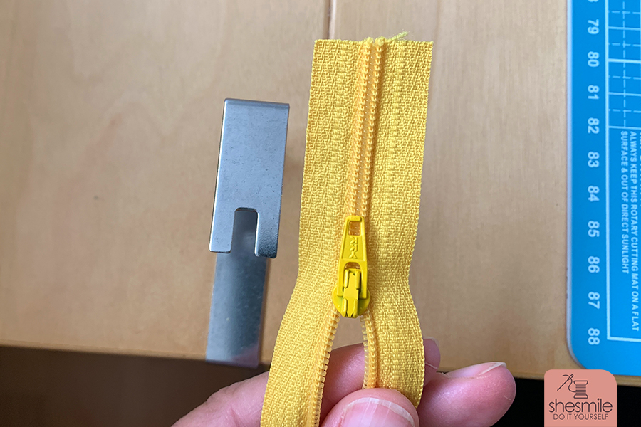 Eine Schritt-für-Schritt Fotoanleitung. Man denkt es wär total kompliziert, ist es aber überhaupt nicht. Hier zeig ich euch wie schnell und einfach mal den Zipper auf einen Endlosreißverschluss auffädelt. Den Reißverschluss an einem Ende etwas öffnen und an der rechten Seite ein Stück der Kette herausschneiden. Den Zipper zuerst links einfädeln ... dann auch rechts (wie bei einer Jacke). Die Enden festhalten und den Zipper auf die Kette ziehen. Und Zack! ist er schon drauf. Die Enden nun noch gleichmäßig zurückschneiden. Die Kette an einer Seite vorsichtig öffnen und testen ob sich der Zipper gut schieben lässt. Für besonders lange Reißverschlüsse, wie bei meiner Sporttasche, die gleichen Arbeitsschritte einfach nochmal von der anderen Seite aus Wiederholen. Viel Spaß beim Nachmachen!