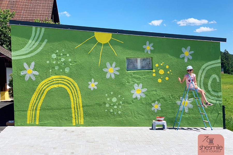Außenwand verspachteln und mit Moltofil Außen verputzen, Risse und losen Untergrund sanieren, mit einem Wandbild bunt streichen, verschönern und anmalen. Konturen zeichnen mit dem Edding 950 Industrie Pastenmarker. Außenwand im Garten gestalten (Teil 3 der shesmile SchönerWohnen-Serie)