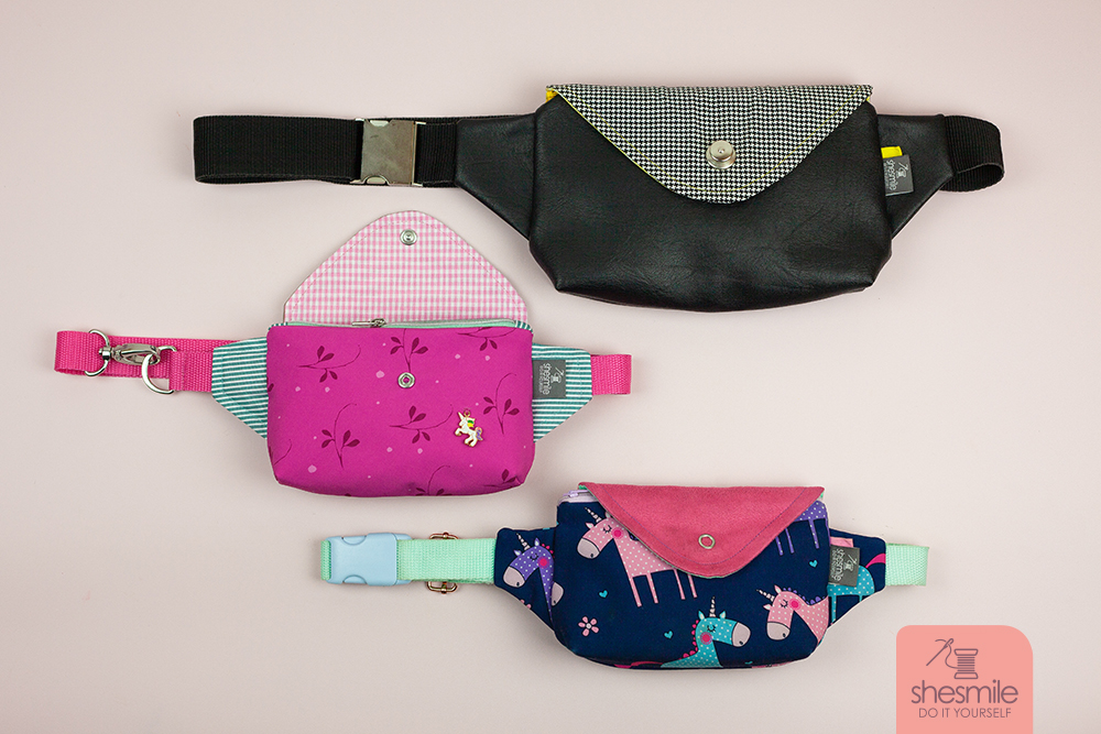 Eine große HipPack aus schwarzem Leder mit gelben Akzenten für die Mama, eine kleine HipPack aus Einhorn-Softshell kombiniert mit pinkem Wildleder für die Große und - ganz neu - jetzt auch eine kleine HipPack aus Softshell für die kleine Tochter. Alle zufrieden und glücklich. Schön!
