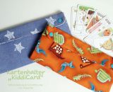 Kartenhalter KiddiCard aus Stoff. Eine Nähanleitung mit Schnittmuster von shesmile. Ideal für Unterwegs oder Zuhause. Aufgeklappt, zusammengesteckt, Spielkarten aus der intgegrierten Tasche rausgeholt und schon kann die Spielpartie losgehen. Ergebnis