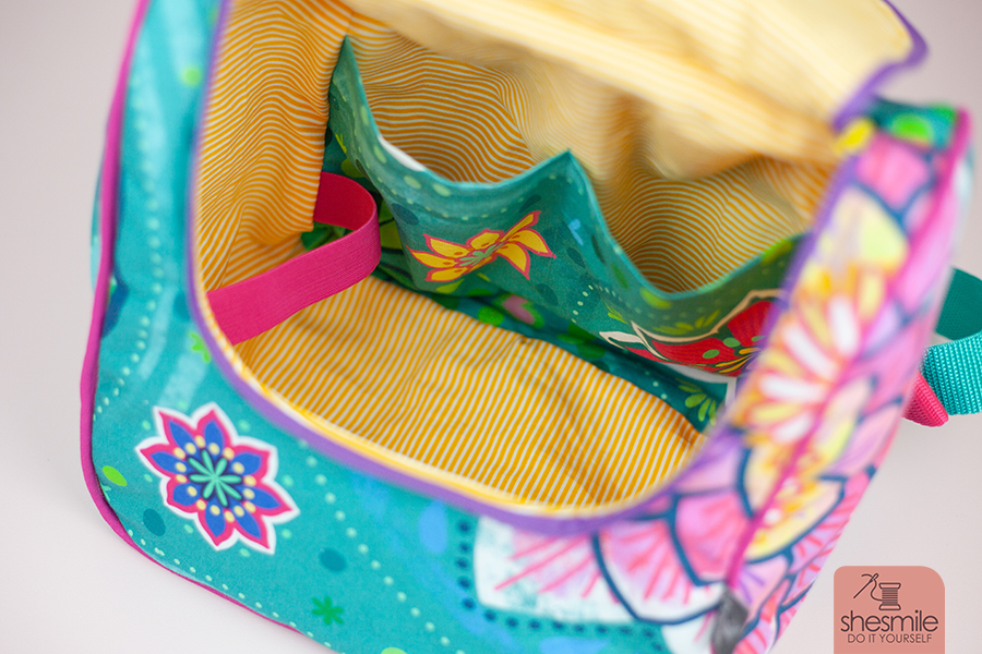 Nähanleitung und Schnittmuster in 3 Größen gestaltet als PDF-E-Book von shesmile DIY für die Tasche KlappAuf. Als Rucksack genäht aus dem Seerosenstoff von Bine Brändle. Die perfekte Kulturtasche, Picknick-Tasche oder Wickeltasche mit praktischer Klappe zum Öffnen nach oben.