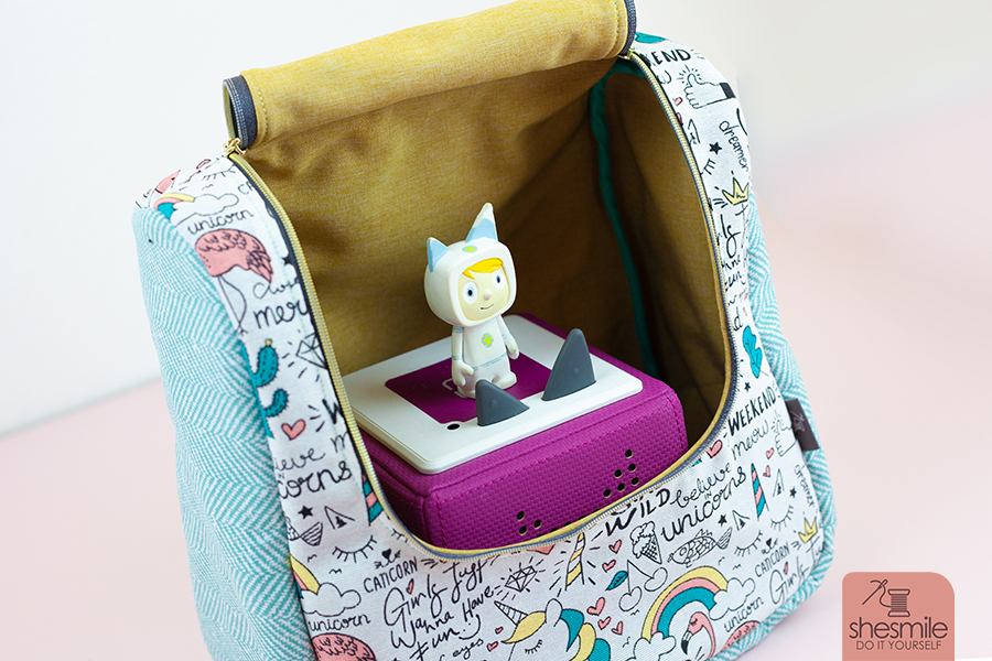 Nähanleitung und Schnittmuster in 3 Größen gestaltet als PDF-E-Book von shesmile für die Tasche oder Rucksack KlappAuf. Einsatzbereit als Kulturtasche, Kosmetiktasche, Transporttasche oder Rucksack für die Toniebox, Lenkertasche, Kindergarten-Rucksack, Lunchtasche, Picknick-Tasche oder Wickeltasche mit praktischer Klappe zum Öffnen nach oben.