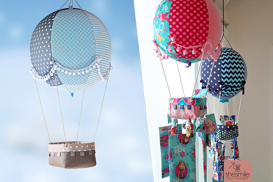 Nähanleitung und Schnittmuster gestaltet als PDF-E-Book von shesmile für einen Adventskalender und Kinderzimmerdeko Adventsballon in Form eines Heißluftballons. 24 kleine Geschenke oder ein Musikwürfel finden ihren Platz an den Halteschlaufen am Körbchen oder im Körbchen selbst.