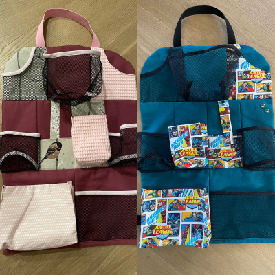 Wir hatten lange nur einen gekauften Sitzschoner ohne Taschen für meinen Sohn. Als die Beine meiner Tochter lang genug waren, dass sie auch einen Schoner brauchte, dachte ich, ich verarbeite mal die Stoffreste, die ich noch da hatte. Der Sohn hat ein cooles Superhelden Muster und sich noch zwei Dino Knöpfe ausgesucht. Die Tochter hat Teile des Kissenbezugs aus ihrem Kinderzimmer. Genug Platz für Tonieboxen, Bücher, Snacks und was sonst alles noch unterwegs mit muss. Es war super einfach zu nähen und die Auswahl der Fächer hat richtig Spaß gemacht!